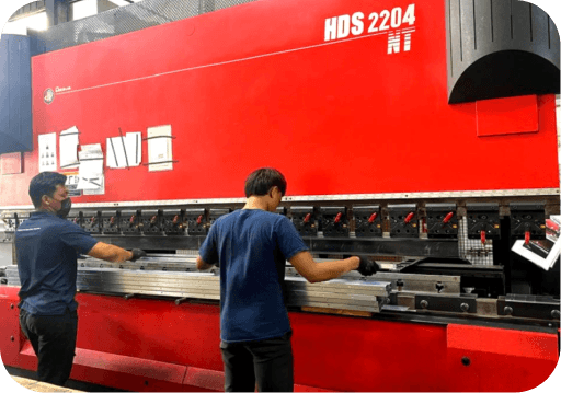 Technician operating a sheet-metal press brake machine