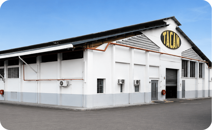 Tacam factory building exterior with signage