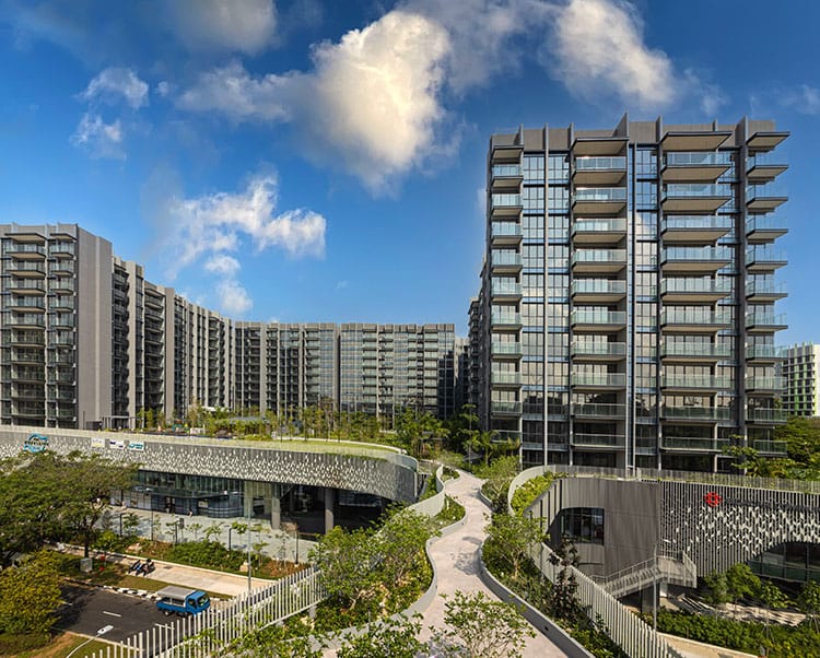 Aerial view of a high-rise residential and retail complex with rooftop gardens