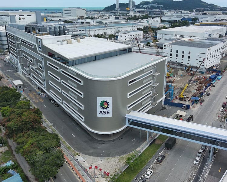 Aerial view of the ASE building complex beside a construction site